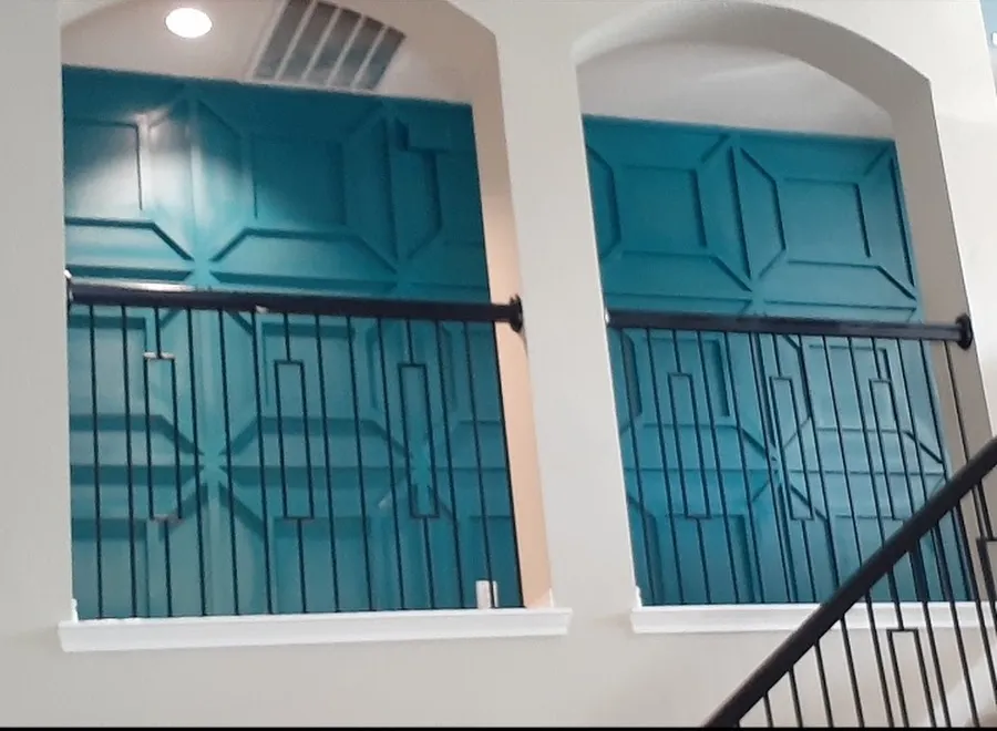Teal painted paneled accent walls in two arched niches