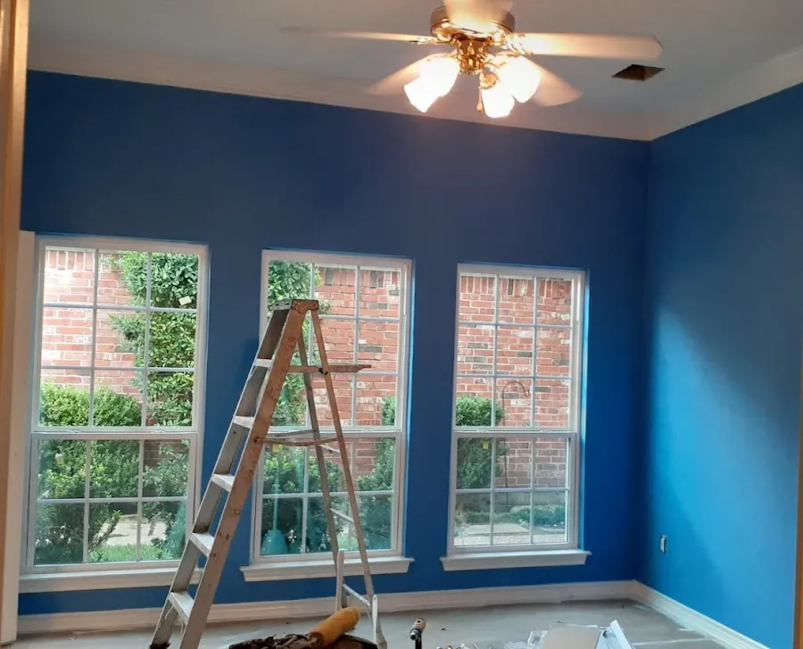 Bedroom painted a bright blue with crisp white trim